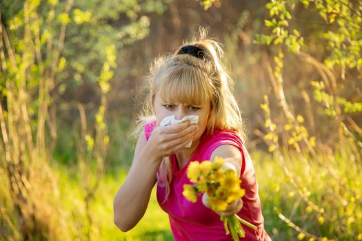 The woman is allergic to flowers. Selective focus. nature