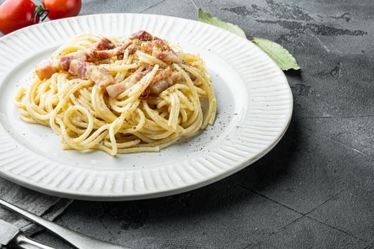 Classic Homemade Pasta carbonara Italian with Bacon, eggs, Parmesan Cheese set, on gray stone background, with copy space for text