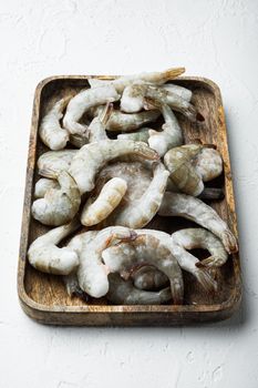 Frozen shell on Tiger Prawns or Asian tiger Shrimps set, on wooden tray, on white stone surface