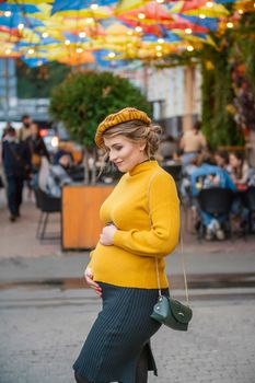 pregnant woman walking through city streets