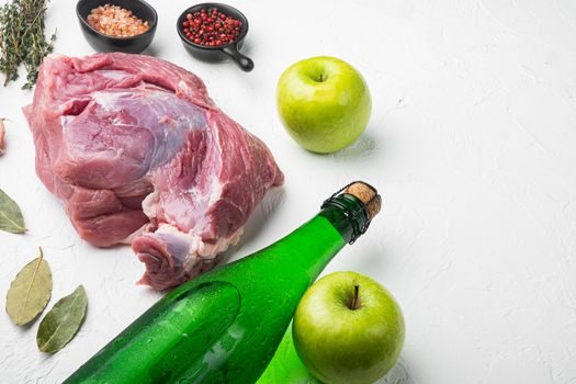 Pork roast, preparation set, with apple dry cider, on white stone table background, with copy space for text