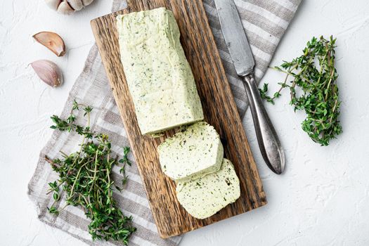 Homemade Organic Herb Butter with Rosemary Thyme and garlic set, on white stone background