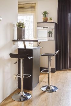 Modern black kitchen chairs in the corner of the kitchen