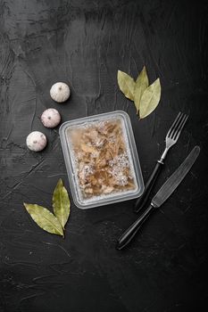 Jellied meat set, on black dark stone table background, top view flat lay, with copy space for text