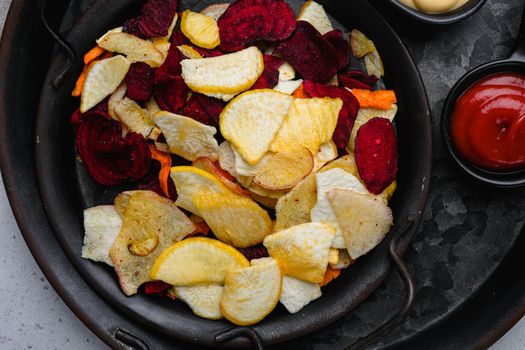 Root Vegetable Crisps set, on gray stone table background, top view flat lay
