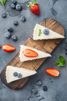 Classic New York Cheesecake, sliced, on gray background, top view flat lay
