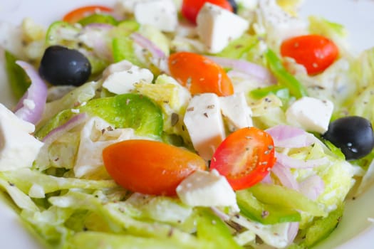 Close up of greek salad in a bowl on table