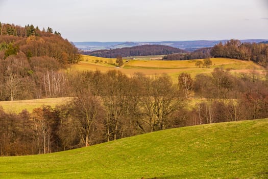 Rural scene with fields, hills and trees in the distance