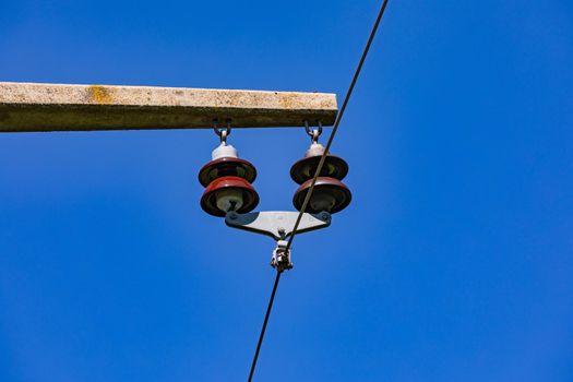 Close up of a power pole with insulators and a power line in Germany