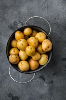 Baby potato, on gray stone table background, top view flat lay, with copy space for text