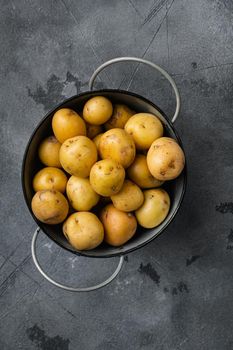 Baby potato, on gray stone table background, top view flat lay, with copy space for text