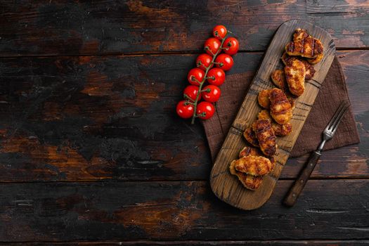 Tasty fried chicken nuggets set, on old dark wooden table background, top view flat lay, with copy space for text