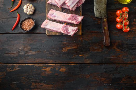 Pork rib with ingredients set , with old butcher cleaver knife, on old dark wooden table, top view flat lay, with copy space for text