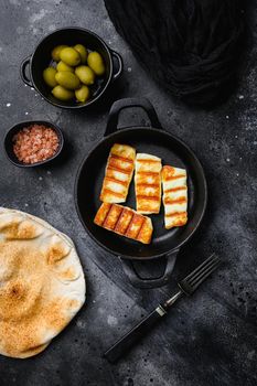 Halloumi fried cheese set, on black dark stone table background, top view flat lay