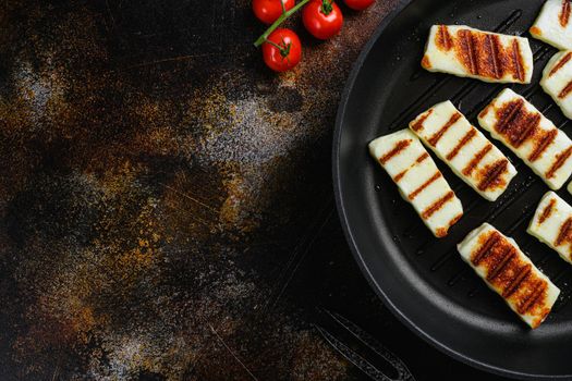 Grilled Halloumi, fried cheese set, on old dark rustic table background, top view flat lay, with copy space for text