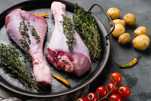 Fresh turkey legs with ingredients for cooking set, on gray stone table background