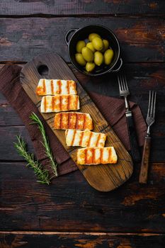 Traditinal Cypriot Halloumi Cheese set, on old dark wooden table background, top view flat lay