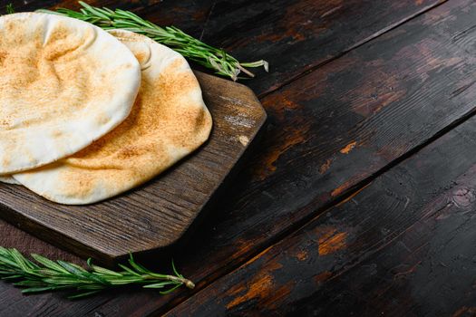 Pita bread on kitchen, on old dark wooden table background, with copy space for text