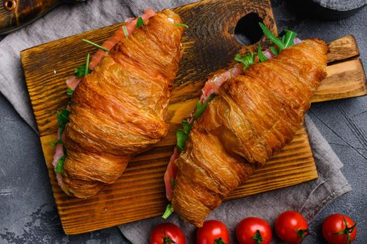 Croissant with salmon and cream cheese set, on gray stone table background, top view flat lay