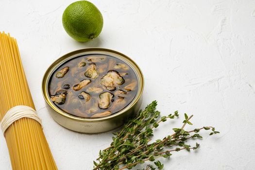 canned seafood mussels in oil set, on white stone table background, with copy space for text