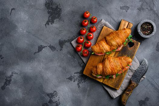 Croissant sandwich with salmon set, on gray stone table background, top view flat lay, with copy space for text