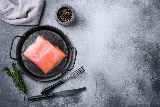 Fresh salmon fillet cut, on gray stone table background, top view flat lay, with copy space for text