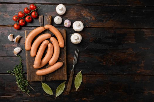 Sausages, on old dark wooden table background, top view flat lay, with copy space for text