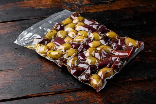 Pickled Olives in Vacuum Sealed Bag set, on old dark wooden table background