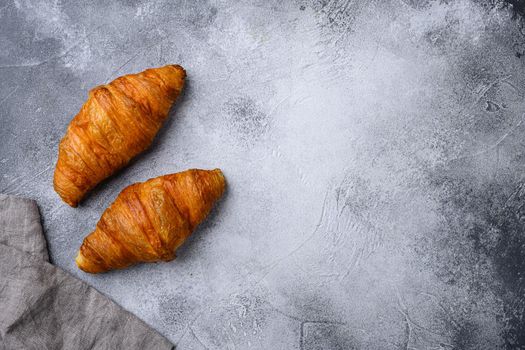 Fresh croissants on table, on gray stone table background, top view flat lay, with copy space for text
