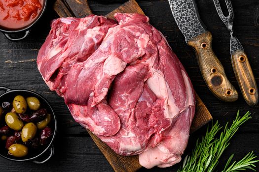 Lamb meat fresh raw set, with ingredients and herbs, on black wooden table background, top view flat lay