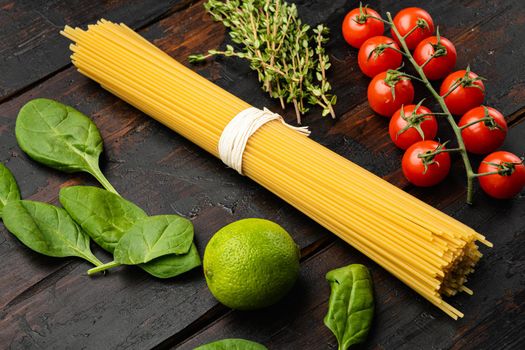 Original Italian raw dry pasta set, on old dark wooden table background