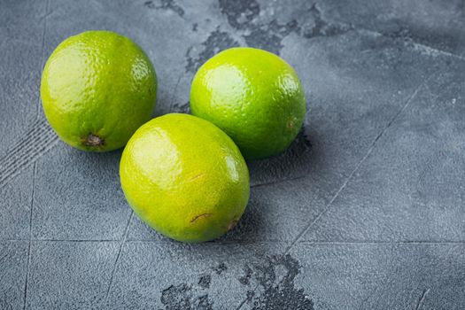 Ripe green lime set, on gray background with copy space for text