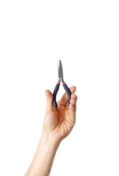pliers for repair in the hands of a male isolate. Selective focus. People.