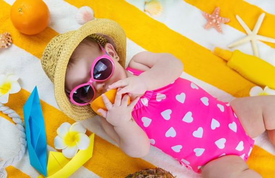 Baby on a beach towel at the sea. Selective focus. Child.