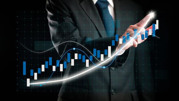 Businessman draw finance allusive graph chart showing business profit growth increasing to future target . Excellent financial status of corporate business rise up . Finance and money technology .