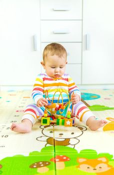 Baby plays with an educational toy. Selective focus. Child.