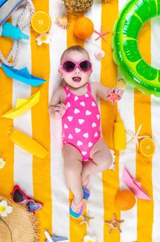 Baby on a beach towel at the sea. Selective focus. Child.