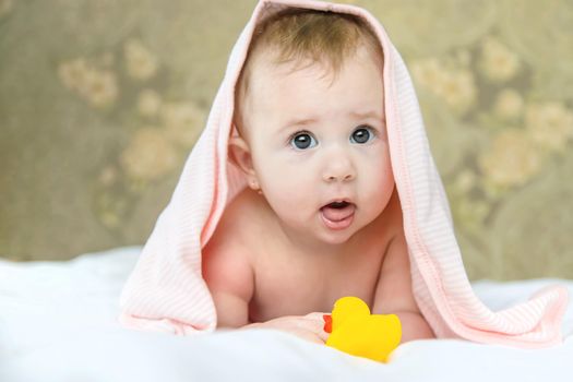 Baby after bathing in a towel. Selective focus. Child.