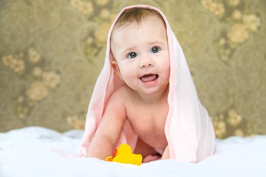 Baby after bathing in a towel. Selective focus. Child.