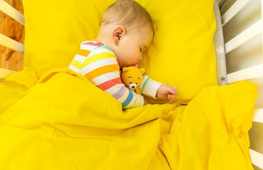 Baby goes to bed in the crib. Selective focus. Child.