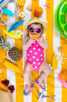 Baby on a beach towel at the sea. Selective focus. Child.