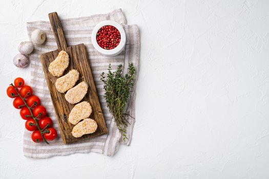 Homemade Raw Breaded Chicken Nuggets, on white stone table background, top view flat lay, with copy space for text