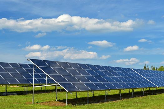 Solar power plant - concept for electricity and ecological industry. High energy prices. Beautiful landscape and sunny day with blue sky. Photovoltaic power plant.