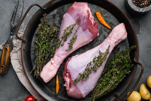 Raw turkey thigh with spices set, on gray stone table background, top view flat lay