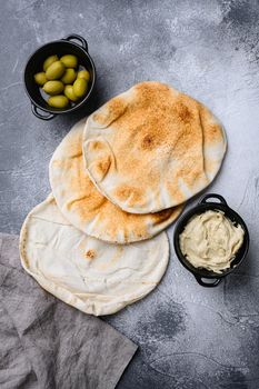 Hummus traditional Jewish creamy lunch , on gray stone table background, top view flat lay, with copy space for text