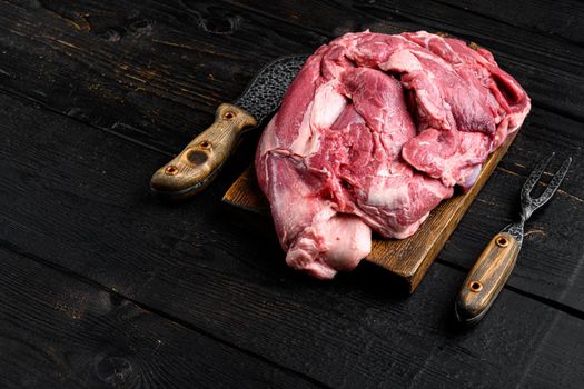 Raw lamb fillet Fresh organic meat set, on black wooden table background, with copy space for text
