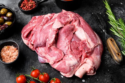 Fresh and raw meat Lamb or mutton set, with ingredients and herbs, on black dark stone table background