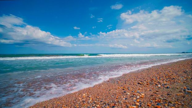Black Sea waves in sunny day. Beautiful seascape. View from Seashore, blue sky, summer landscape at the sea.