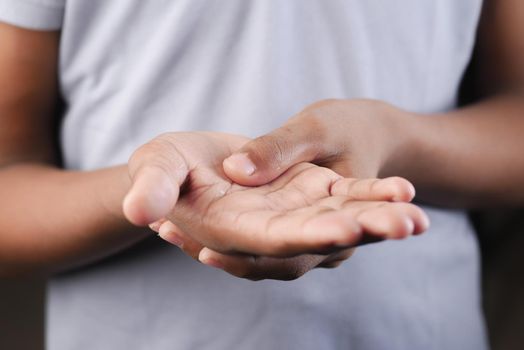 man suffering pain in hand close up .
