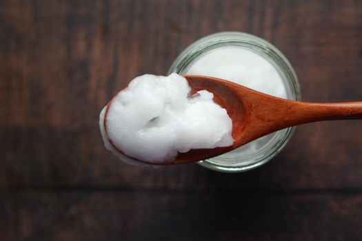 cold oil coconut on a wooden board .